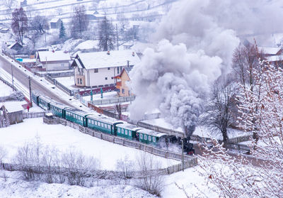 High angle view of steaming traing going through a village 