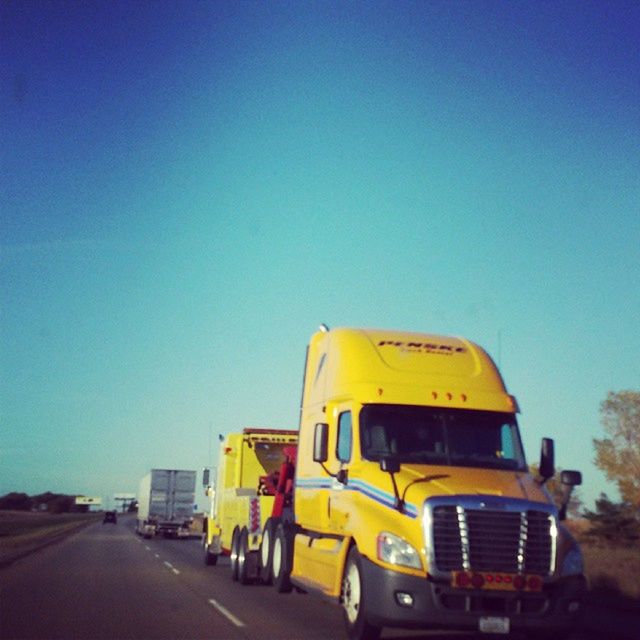 transportation, clear sky, land vehicle, car, mode of transport, blue, copy space, yellow, road, street, building exterior, architecture, built structure, stationary, outdoors, the way forward, travel, day, on the move, no people