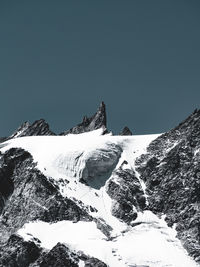 Scenic view of snowcapped mountains against clear sky