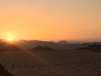 Scenic view of desert against sky during sunset