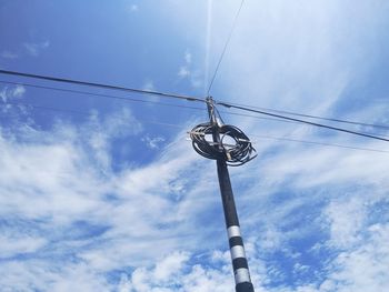 Low angle view of street light against cloudy sky