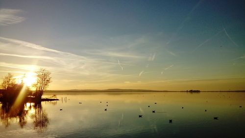 Scenic view of lake against sky during sunset