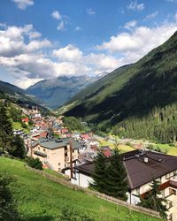 Scenic view of houses and mountains against sky