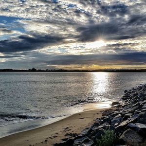 Scenic view of sea against cloudy sky