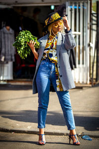 Full length of woman walking on footpath