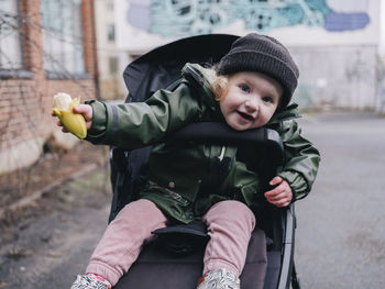 Portrait of girl sitting in stroller