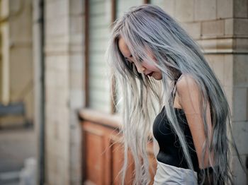 Young woman standing in front of building