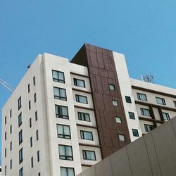 Low angle view of buildings against clear blue sky