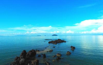 Scenic view of sea against blue sky