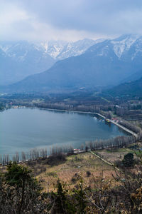 Scenic view of river with mountain range in background