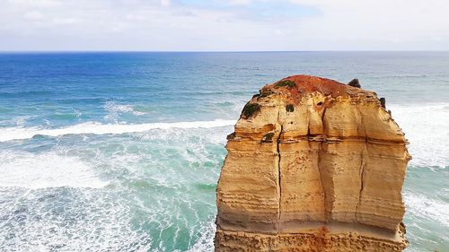 View of rock formation on beach against sky