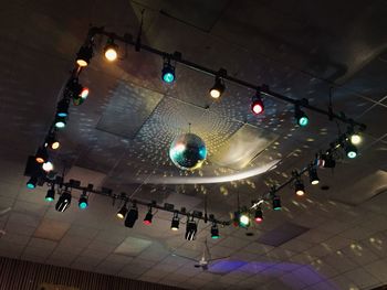 Low angle view of people on illuminated ceiling