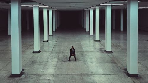 Man walking in corridor of building