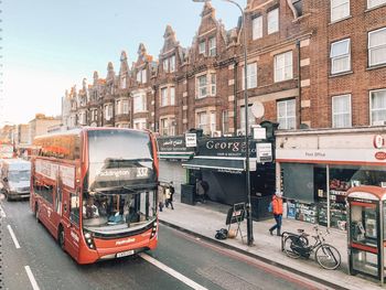 Vehicles on road against buildings in city