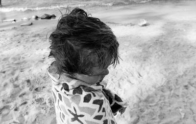 Close-up of boy at sandy beach