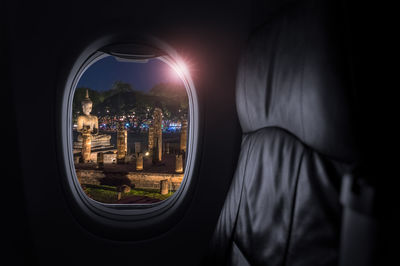 Airplane interior with window view of sukhothai historical park, 