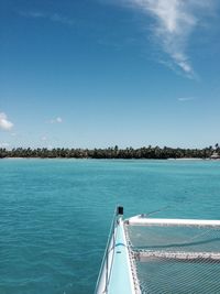 Cropped boat sailing on sea against blue sky
