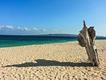 Scenic view of beach against blue sky