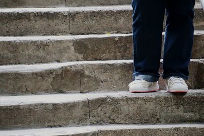 Low section of person standing on staircase