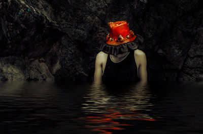 Woman standing on rock by sea