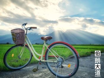 Bicycle on field against sky