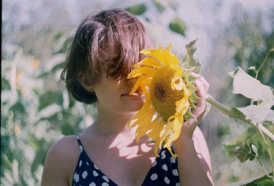 Woman holding sunflower