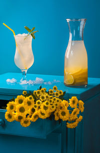 Close-up of yellow flowers on glass table