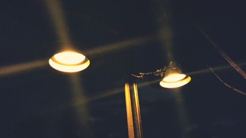 Low angle view of lamp post at night