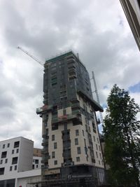Low angle view of building against cloudy sky