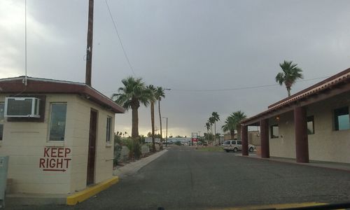 Empty road along buildings