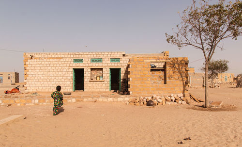 People outside building against clear sky