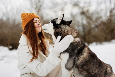 Smiling young woman with dog