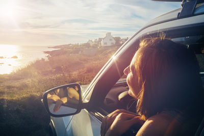 Rear view of woman sitting in car