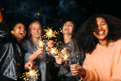 Friends enjoying sparklers at night