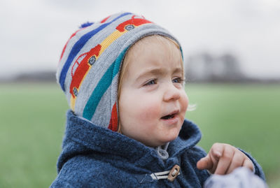 Close-up portrait of cute boy wearing hat