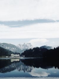 Scenic view of lake by trees against sky