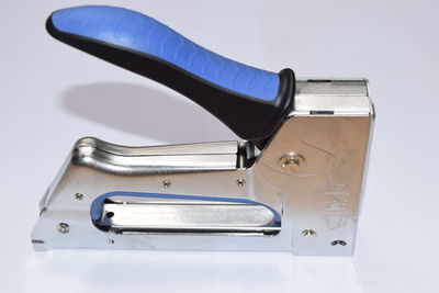 Close-up of stapler on white background