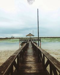 View of jetty leading to sea