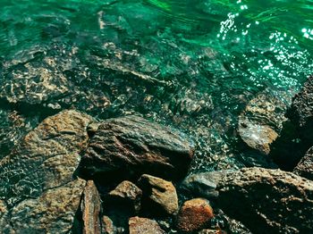 High angle view of rocks in sea