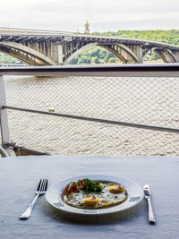 Close-up of fried egg served in plate on table at cafe