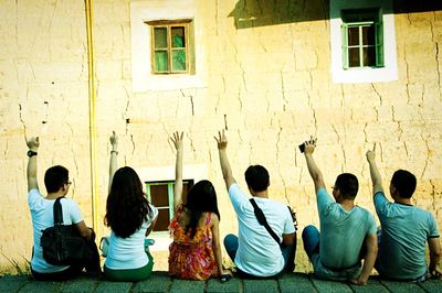 Woman standing by wall