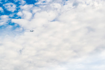 Low angle view of airplane flying in sky
