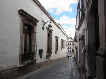 Street amidst buildings against sky