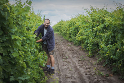 Rear view of man walking in farm