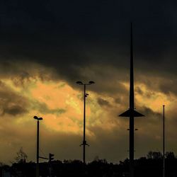 Low angle view of street light against cloudy sky