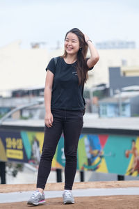 Portrait of smiling young woman standing outdoors