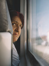 Portrait of man seen through train window