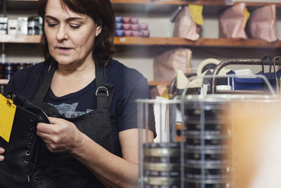 Midsection of woman working at store