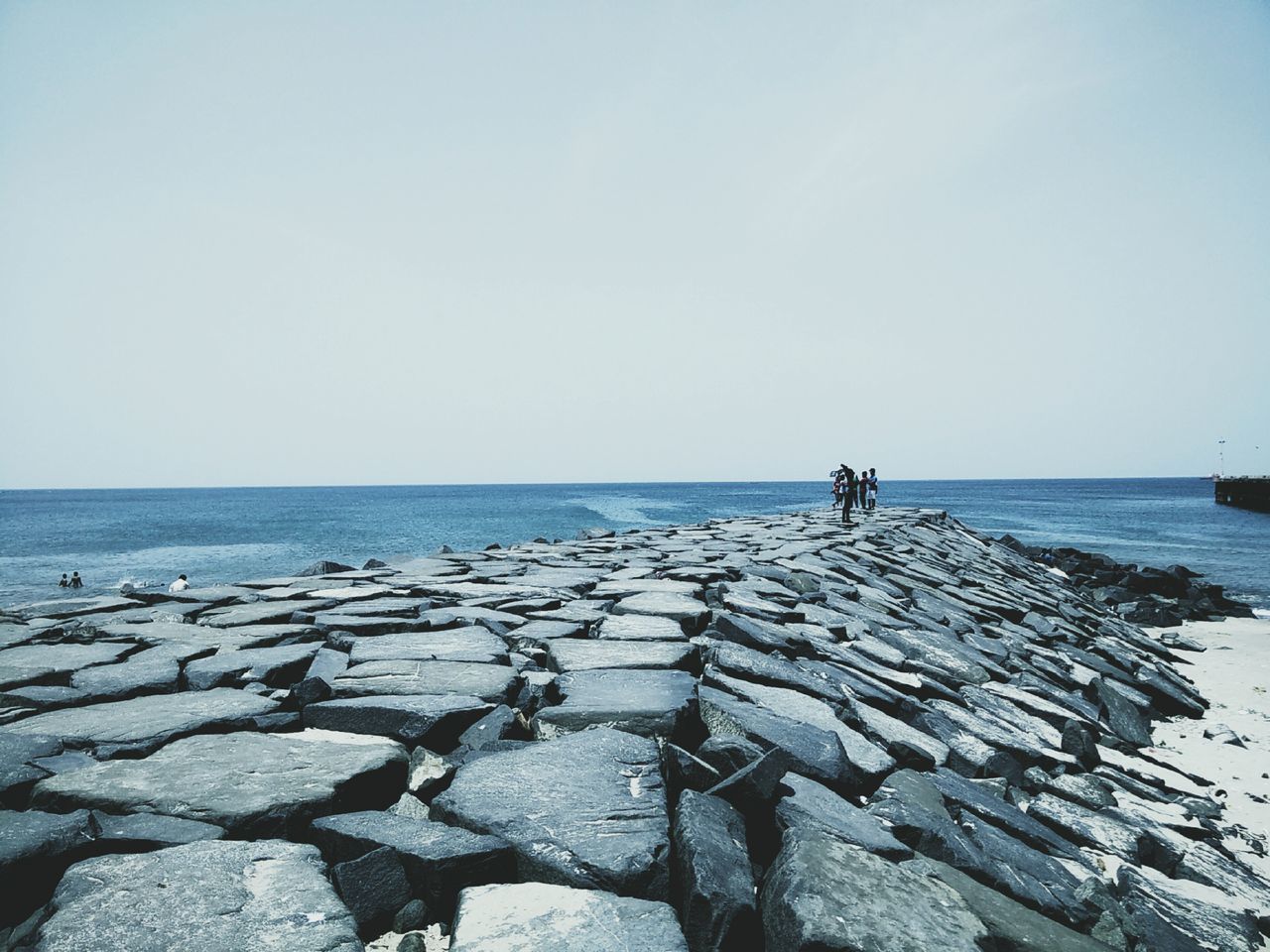 sea, horizon over water, water, clear sky, copy space, rock - object, tranquil scene, tranquility, scenics, beauty in nature, nature, beach, shore, sky, outdoors, day, idyllic, men, stone - object