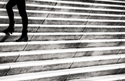 Low section of woman standing on staircase